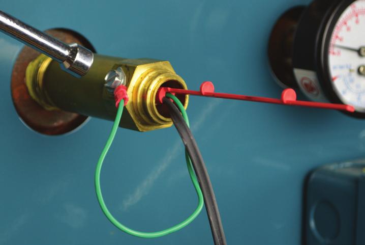 Secure the fork connector on the green sensor wire to the screw inserted into one of the tapped holes on the hex of the brass body of the well. Tighten the screw completely. See Figure 21