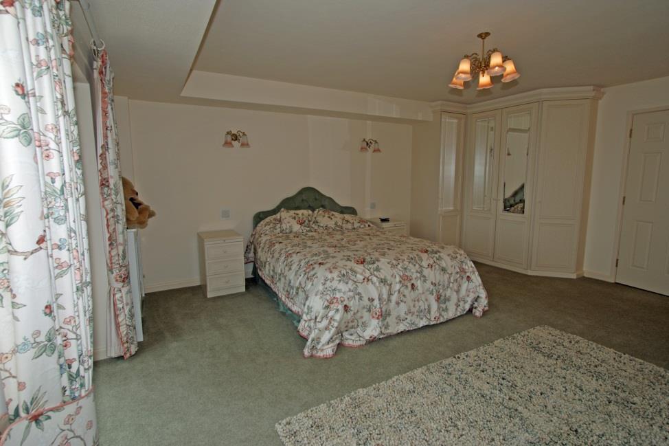 Bedroom Suite 3 Dressing Room 8'8 x 8'6 Four door run of fitted mirror fronted wardrobes. En suite Bathroom.
