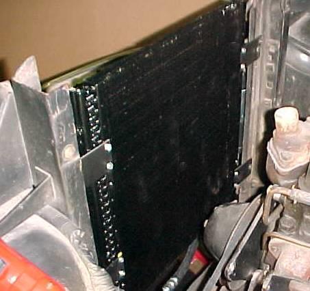 Place condenser assembly inside of radiator mounting frame as shown. Brackets should be inside of frame.