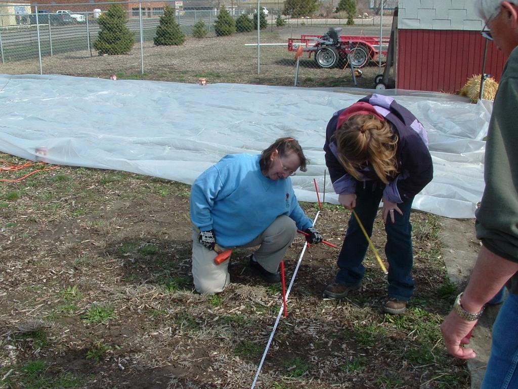 SETTING STAKES After squaring the corners of Hoop House, mark by setting four stakes in the ground at each corner using ½-in. rebar 24 ins. long. Drive these stakes 12 ins.