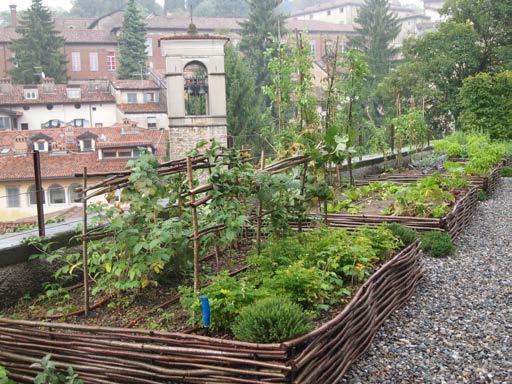 Near the balustrade, four raised vegetable plots offer herbs and encouraging experiments with tomatoes, zucchini and cabbages. Not far, a young espalier pear tree grows against a wall.