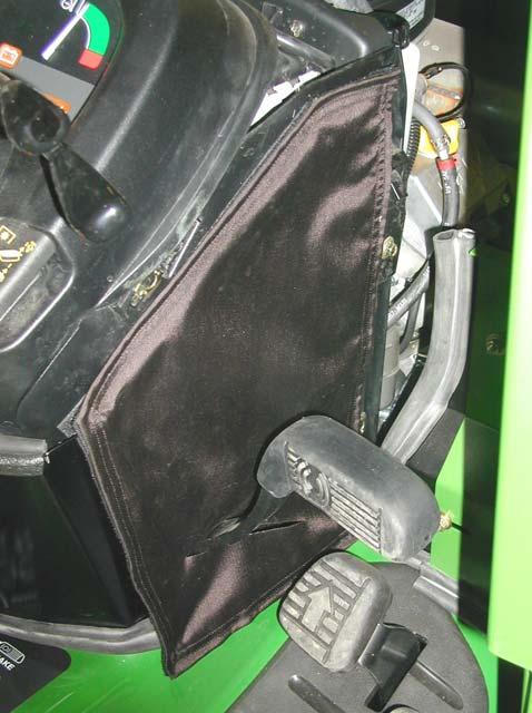 Position the panel to seal around the tractor cowl area.