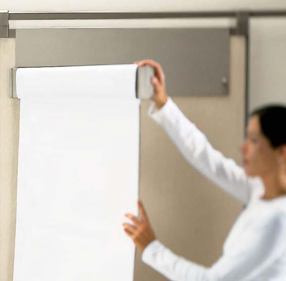 Flip chart holder connects to a wall board. Pivoting arm allows paper to flip easily.
