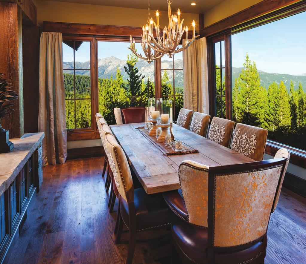 The antler-shaped chandelier branches brighten the room, and the rich, artistic fabric chairs bring elegance to this forest dining experience.