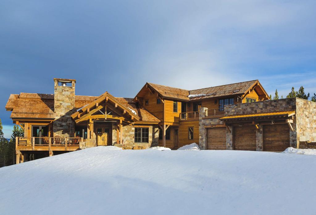 Into the Woods The snow adds natural beauty to this already majestic home with a traditional gable roof. The foundation is primarily made of fir and cedar wood, and Deep Creek ledgestone.