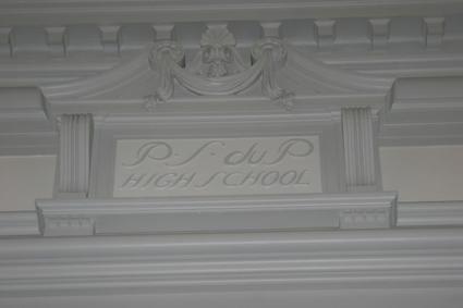The plaster s centerpiece above the stage in the auditorium has the inscription P.S. dup High School.