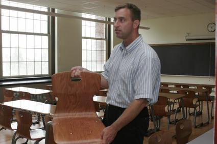 The chairs, which were tested by students, will match the wood décor of the classrooms.