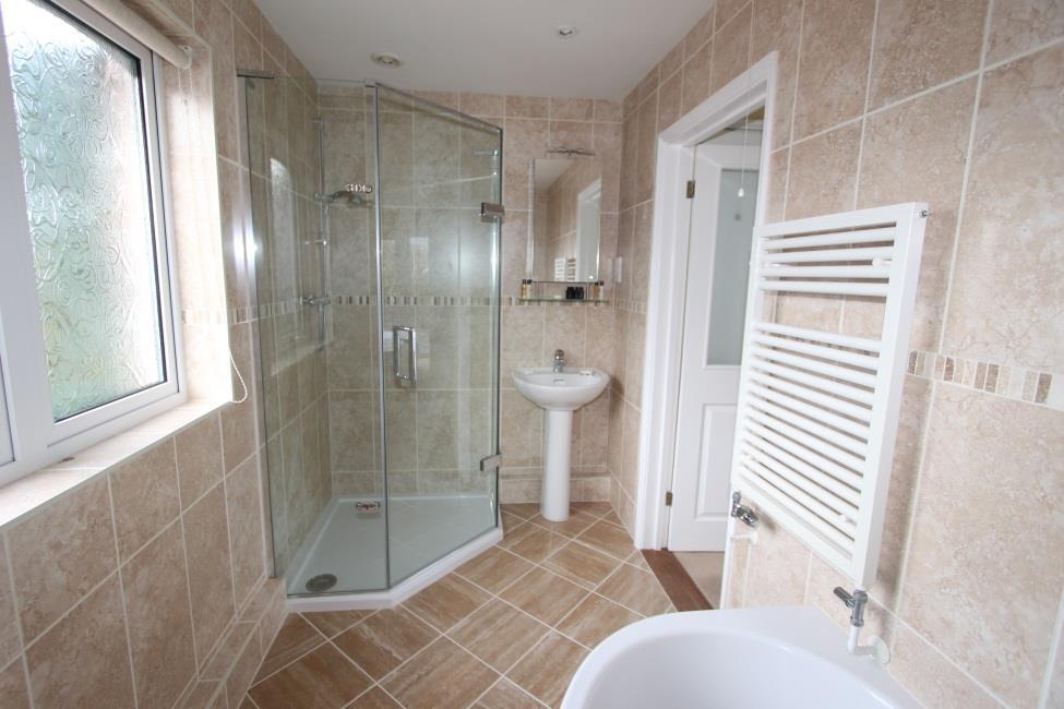 Bathroom White 3 piece Villeroy & Boch suite comprising a spa bath with Aqualisa shower fitting over and glazed modesty screen, low flush wc and