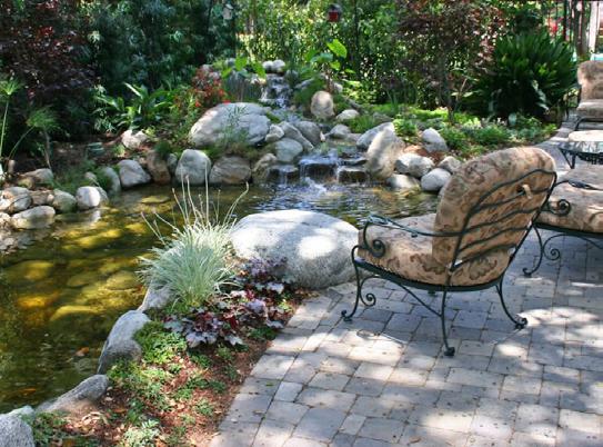 2. Ponds A pond with darting fish, floating and surrounding plants, and a cascading waterfall can really complete your backyard living space.