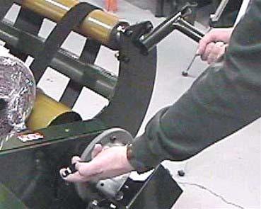 Push the roll off of the machine and return the Right Hand Side Cradle to its Normal locked position.