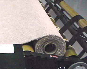 Once you see the carpet is starting to wrap around the core, release the Handle to its original position.