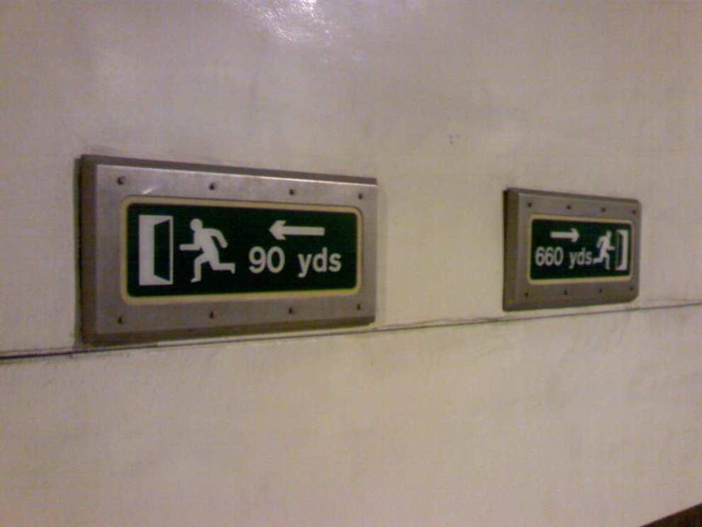 EMERGENCY WAY FINDING SIGNS Illuminated distance to exit signs installed at 50m intervals Each indicates