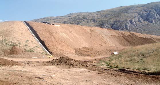 After construction of the final impermeable barrier, a skin of vegetative soil