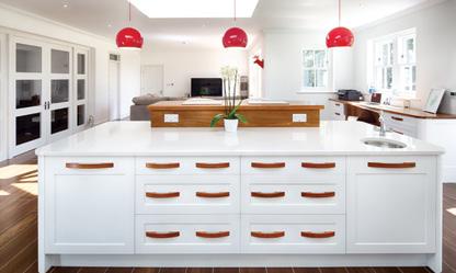 Within the open plan design, height is used at both the breakfast bar and opposite, behind the induction hob, to provide a definition of where the kitchen sits, as distinct from, but linked to the