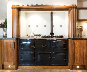 COLLINGHAM Art Deco walnut and stainless steel kitchen Designed and made in American black walnut in an Art Deco style this kitchen provides a compact accessible cooking and preparation area with