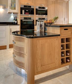 Reflective plinths on the island combine practicality with a freestanding look, while the breakfast bar support doubles as tray storage.