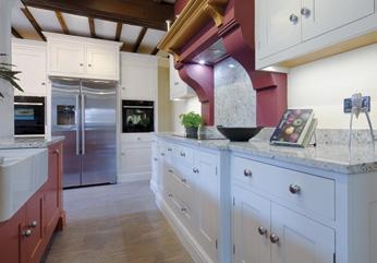 HARROGATE Sophisticated hand painted kitchen with granite work-surfaces and oak preparation block This Harrogate kitchen is a great blend of country and town living, with co-ordinated cooking,