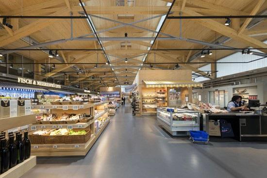 Inside the nearly 1,000-square-metre store, the design is also dominated by wood untreated wooden trusses for the hall s