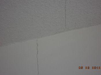 At the back addition area there are minor straight line cracks at the ceiling and wall above the opening to the room at the original exterior wall.