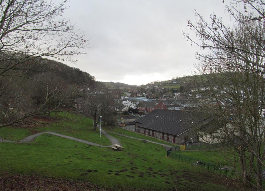 The Bryn y Castell scheduled monument is situated at the northern corner of the recreation ground. It is separated from the supermarket site by the community centre, public car park and drill hall.