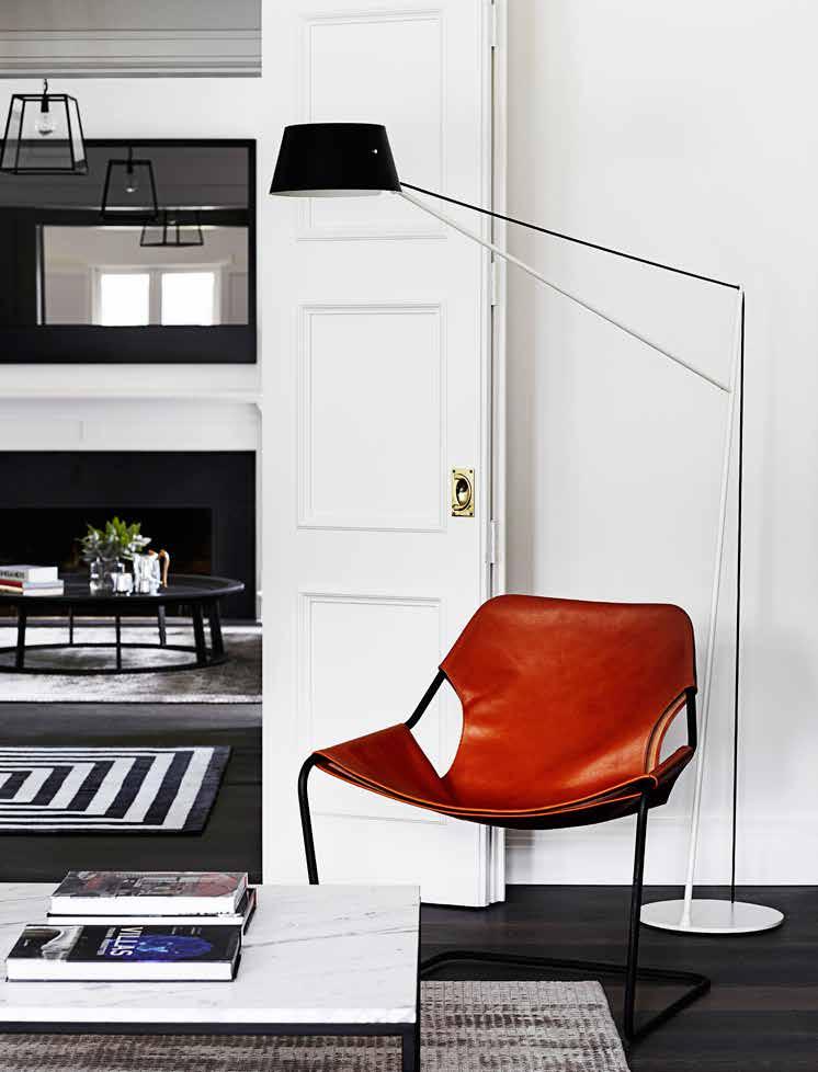 melbourne home this page In the casual living room is a Paulistano leather armchair, Spar floor light by Jamie McLellan, and black steel and marble coffee table designed and made by Robson Rak.