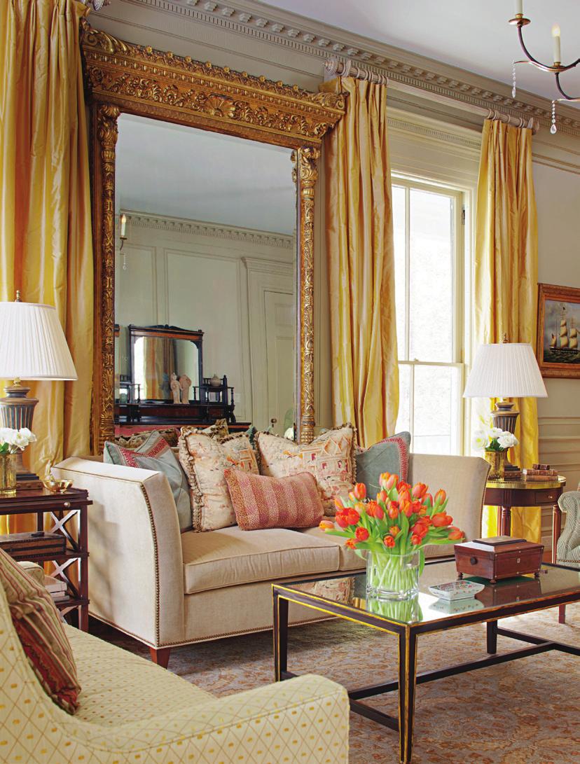 this Photo: a gilded plaster-frame mirror that has hung in the house since the 1930s anchors the living room.