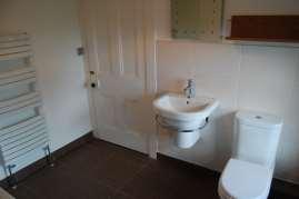 99 m The shower room has vinyl flooring, an opaque window through to the conservatory, an extractor fan, a ladder radiator and comprises a WC, a wash hand basin with mixer tap and a wet walled shower