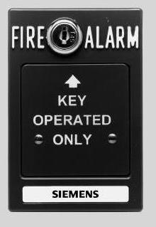 the alarm or double action type, requiring two actions, such as lifting a cover and pulling a