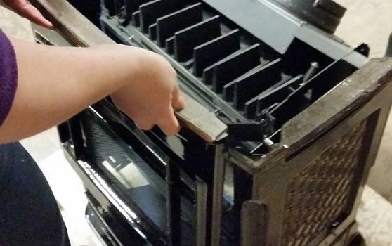 2. Release the front panel by lifting up and off of the stove body. Set aside on a soft surface. Figure 3 Front Panel Removal 3.