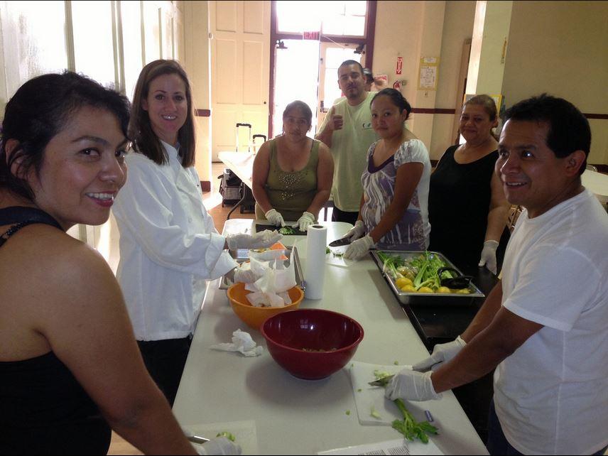 PHOTOS COOKING PROGRAMS: Caption: Community members help prepare the fruits of their labors at the Mariposa Nabi Garden.