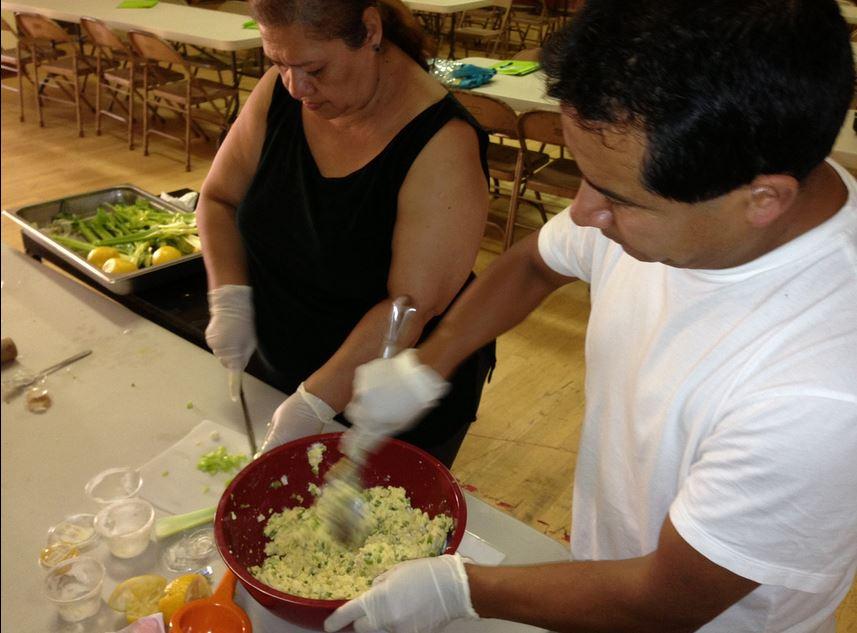 Cooking Programs: Caption: Family members are hard at work learning new ways to prepare