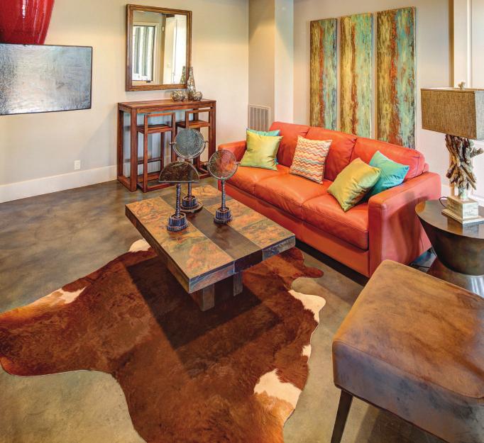 The family room features a bright orange sofa made with wonderfully worn leather. It serves as a comfortable gathering place for family and friends.