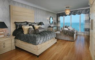 The master bedroom includes a suede bed and headboard with