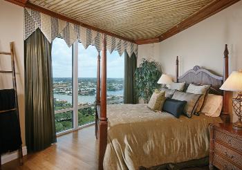Leaning more towards a Key West look, this bedroom features a ceiling painted to resemble bamboo. Flooring is actual bamboo.