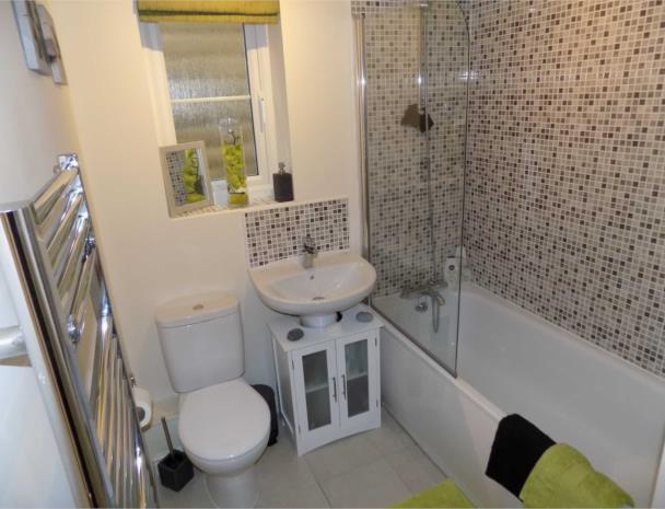 HOUSE BATHROOM 8'4'' X 6'2'' (254m X 188m ) The stylish house bathroom has a three piece Roca suite in white It comprises panelled bath with curved shower screen and from the mixer tap is a wall