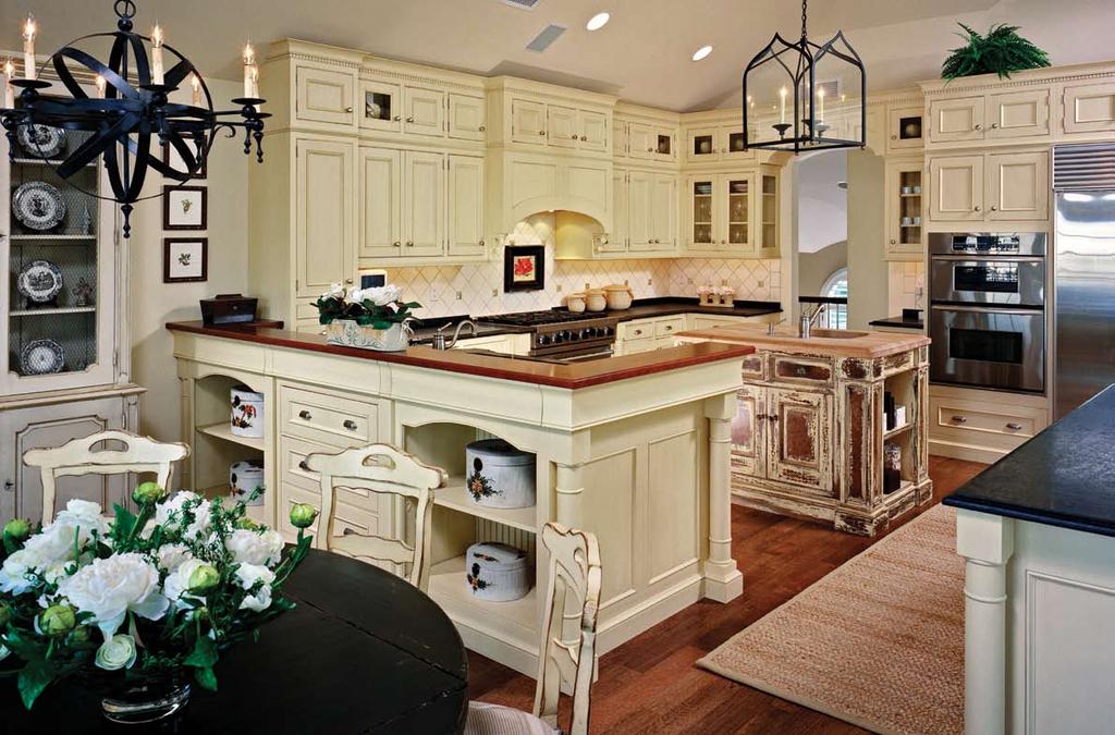 The kitchen, painted yellow with an amber glaze on the cabinets, flows into the living room area.