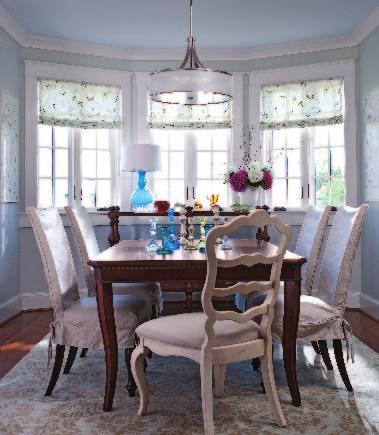Right Slipcovers on the side chairs create a relaxed feel in the dining room.