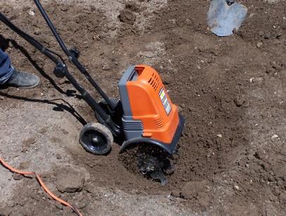 Figure 16. Digging the hole with a small tiller or "garden weeder." Step 3.