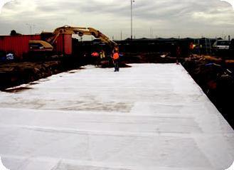 Wrapping tanks in geotextile.