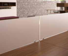 Frosted acrylic privacy screens allow light to filter through and define individual spaces.