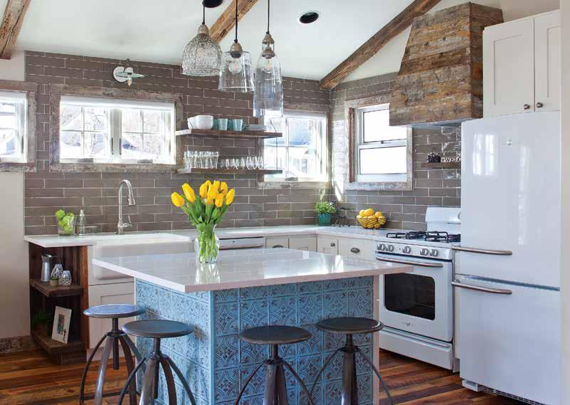 In the kitchen, rustic window trim, ceiling beams and a range hood all fashioned out of the shed s original fir and spruce siding keep the building s history intact.