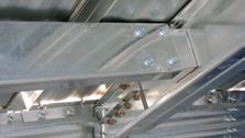 uuindividual pipe sections are clamped and fastened to the roof with a locking bracket at every rib.