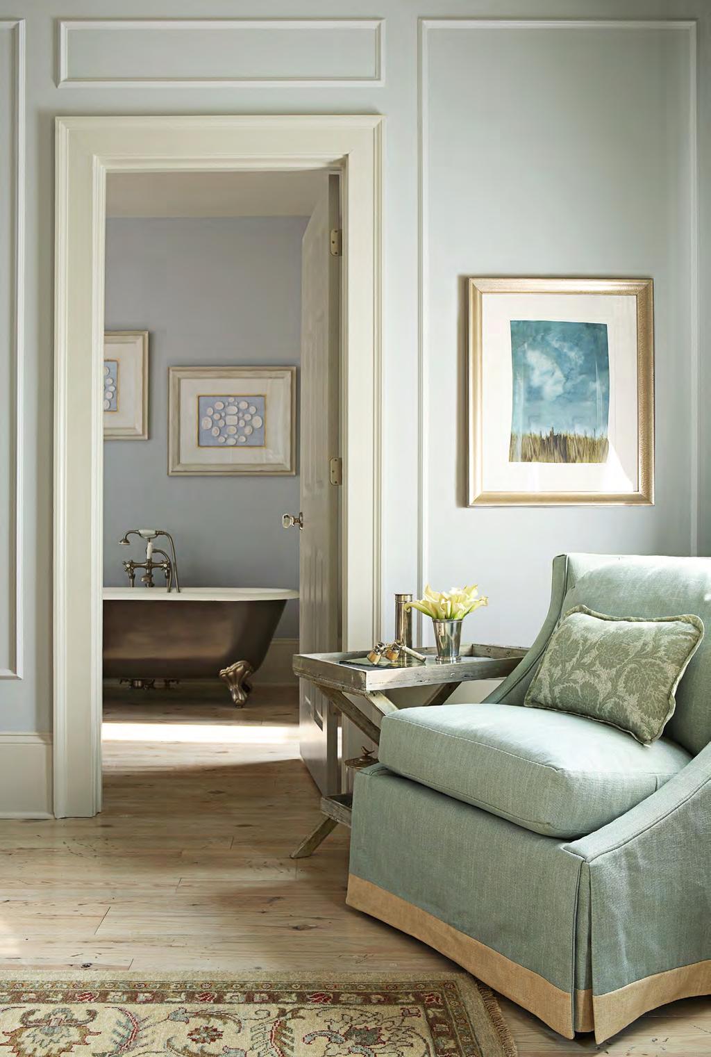 THIS PHOTO: A slipcovered linen side chair is a transition between the master bedroom and bath.