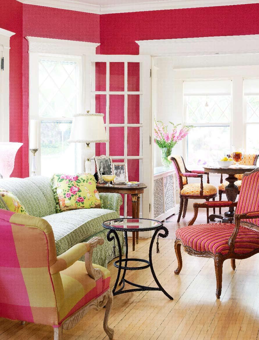 To ease the feminine edge in the living room, Sandra deepened the walls from light pink to rich raspberry and carried the saturated tones