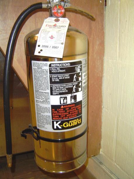 COMMERCIAL KITCHEN FIRE SAFETY These pictures are of a portable K-rated fire extinguisher. A class K fire extinguisher is designed to better control grease and other kitchen related fires.