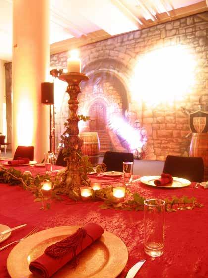 CENTREPIECES: Large table scape of ivy, candles and ornate candelabra TABLE DESIGN: Rich red velvet