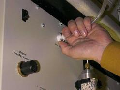 3) Once the tanks are completely drained, push the button on the top of the bulkhead down to release the
