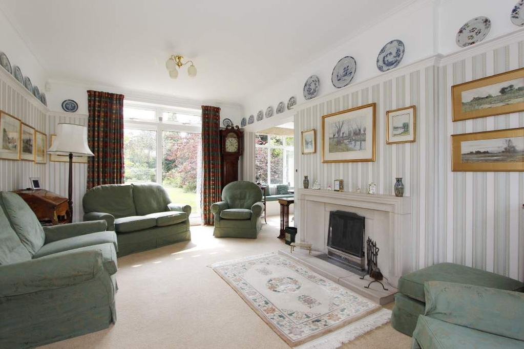A well proportioned 1920s detached house with beautifully presented accommodation and a large south-west facing garden of over a third of an acre,