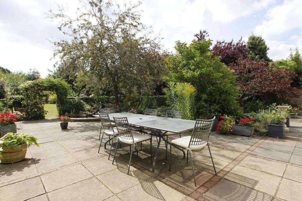 Property Highlights Dual aspect Sitting Room with sliding glazed doors to garden terrace, open fireplace with stone hearth and surround, wide opening to a delightful Snug Area with bay window and