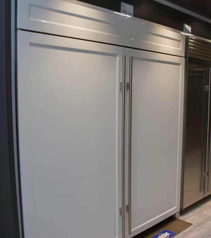 It is a shallow depth, commercially styled refrigerator with the compressor on top.